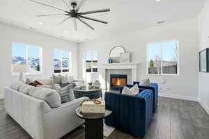 Living room featuring a mountain view, a tiled fireplace, healthy amount of natural light, and recessed lighting