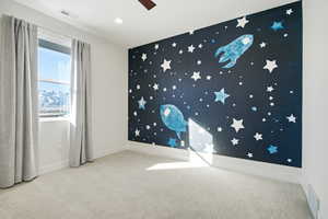 Unfurnished room featuring an accent wall, light colored carpet, a ceiling fan, and recessed lighting