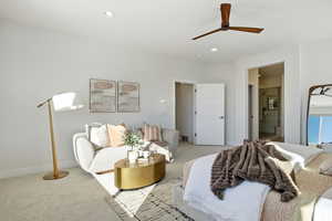 Bedroom with carpet floors, a ceiling fan, ensuite bath, and recessed lighting