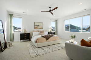 Carpeted bedroom featuring ceiling fan, multiple windows, and recessed lighting