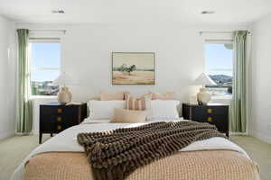 Bedroom with light colored carpet