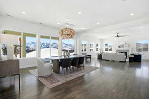 Dining area featuring a mountain view, recessed lighting, dark wood-type flooring, and a tile fireplace