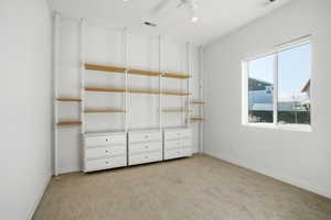 Unfurnished bedroom with light colored carpet, a ceiling fan, and recessed lighting
