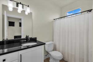 Bathroom featuring a shower with curtain and vanity