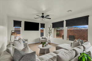Living room with light wood-style flooring and ceiling fan
