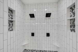 Full bath featuring tiled shower