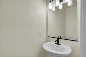 Bathroom featuring a sink and a chandelier