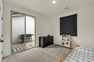 Bedroom featuring carpet flooring, recessed lighting, and access to exterior