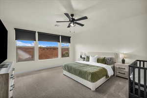 Carpeted bedroom with a ceiling fan