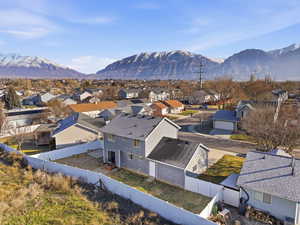 Aerial perspective of suburban area featuring a mountain backdrop