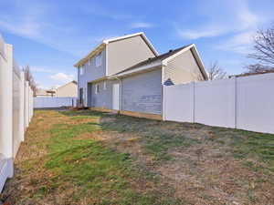View of side of home featuring a fenced backyard
