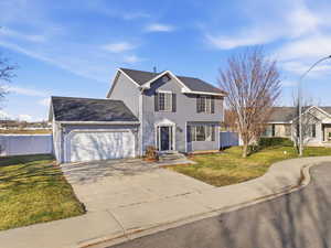 View of front facade featuring driveway, a garage, and a shingled roof