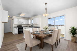 Dining area with healthy amount of natural light and dark wood finished floors
