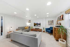 Living room with light carpet and recessed lighting