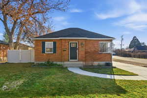 Bungalow-style house featuring brick siding and a shingled roof