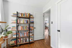 Hallway with dark wood-type flooring