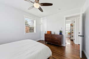 Bedroom with dark wood-style flooring and a ceiling fan