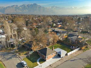 Aerial overview of property's location featuring nearby suburban area and a mountainous background