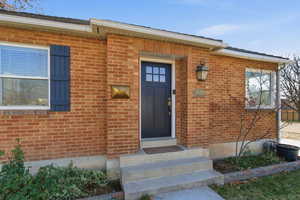Doorway to property with brick siding