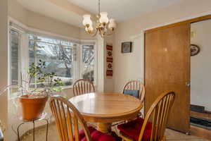 Tiled dining/breakfast area with a chandelier