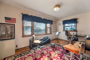 Bedroom or Office space featuring wood finished floors and baseboards