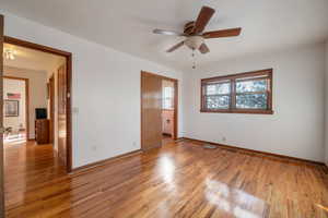 Master bedroom featuring light wood finished floors and ceiling fan