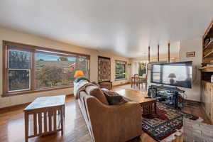Living room with hardwood floors and hardwood blinds
