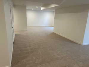 Spare room featuring light carpet and recessed lighting