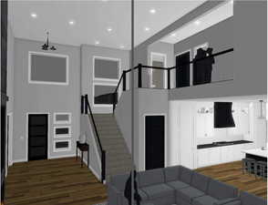 Living area featuring stairway, a high ceiling, dark wood-style floors, and recessed lighting