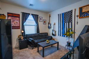 Carpeted living room featuring baseboards