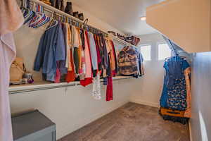 Walk in closet with dark carpet