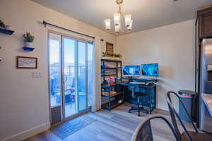 Office space featuring a chandelier and light wood finished floors