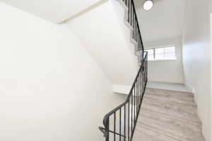 Staircase featuring carpet and baseboards