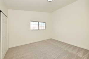 Unfurnished bedroom featuring a closet and carpet