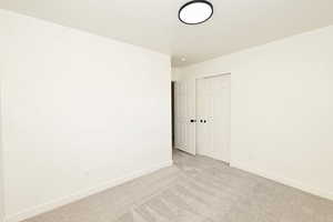 Spare room with carpet and baseboards