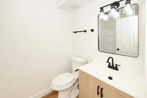 Full bath featuring vanity, a shower, and light wood-style floors