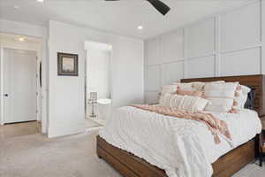 Bedroom with a decorative wall, light carpet, ceiling fan, recessed lighting, and ensuite bath