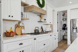 Kitchen featuring open shelves, stainless steel appliances, white cabinetry, decorative backsplash, and recessed lighting