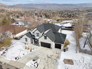 Snowy aerial view with a mountain view and a residential view