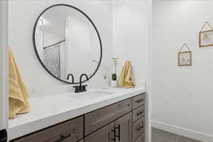 Bathroom with vanity and curtained shower