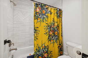 Full bathroom with shower / bath combination with curtain