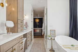 Ensuite bathroom with vanity, a freestanding tub, and a shower stall