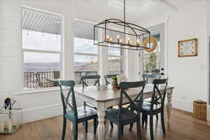 Dining space featuring light wood-style flooring, a mountain view, and a chandelier
