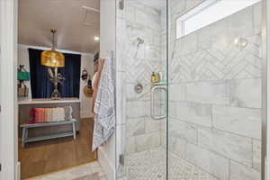 Bathroom featuring a stall shower and ornamental molding