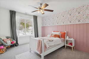 Bedroom featuring wainscoting, a textured ceiling, carpet, ceiling fan, and wallpapered walls