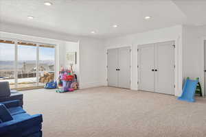 Game room featuring a textured ceiling, carpet floors, and recessed lighting