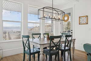 Dining space featuring light wood finished floors and a chandelier