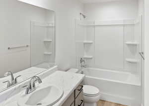 Full bath with vanity, washtub / shower combination, and light wood-style flooring