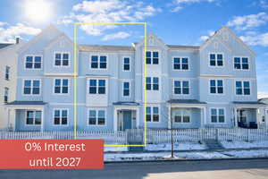 View of front of property featuring a fenced front yard and board and batten siding