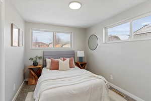 Carpeted bedroom with multiple windows